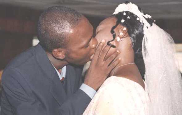 Groom kisses the Bride